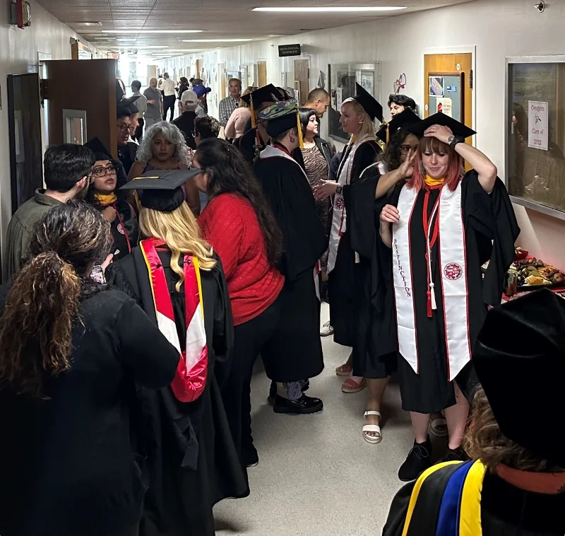 Geological Science students gathering in hallway with family and friends 