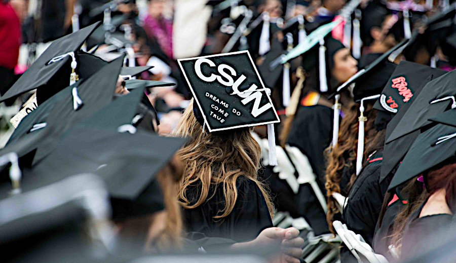 Closeup of graduating students wearing their mortar board caps.