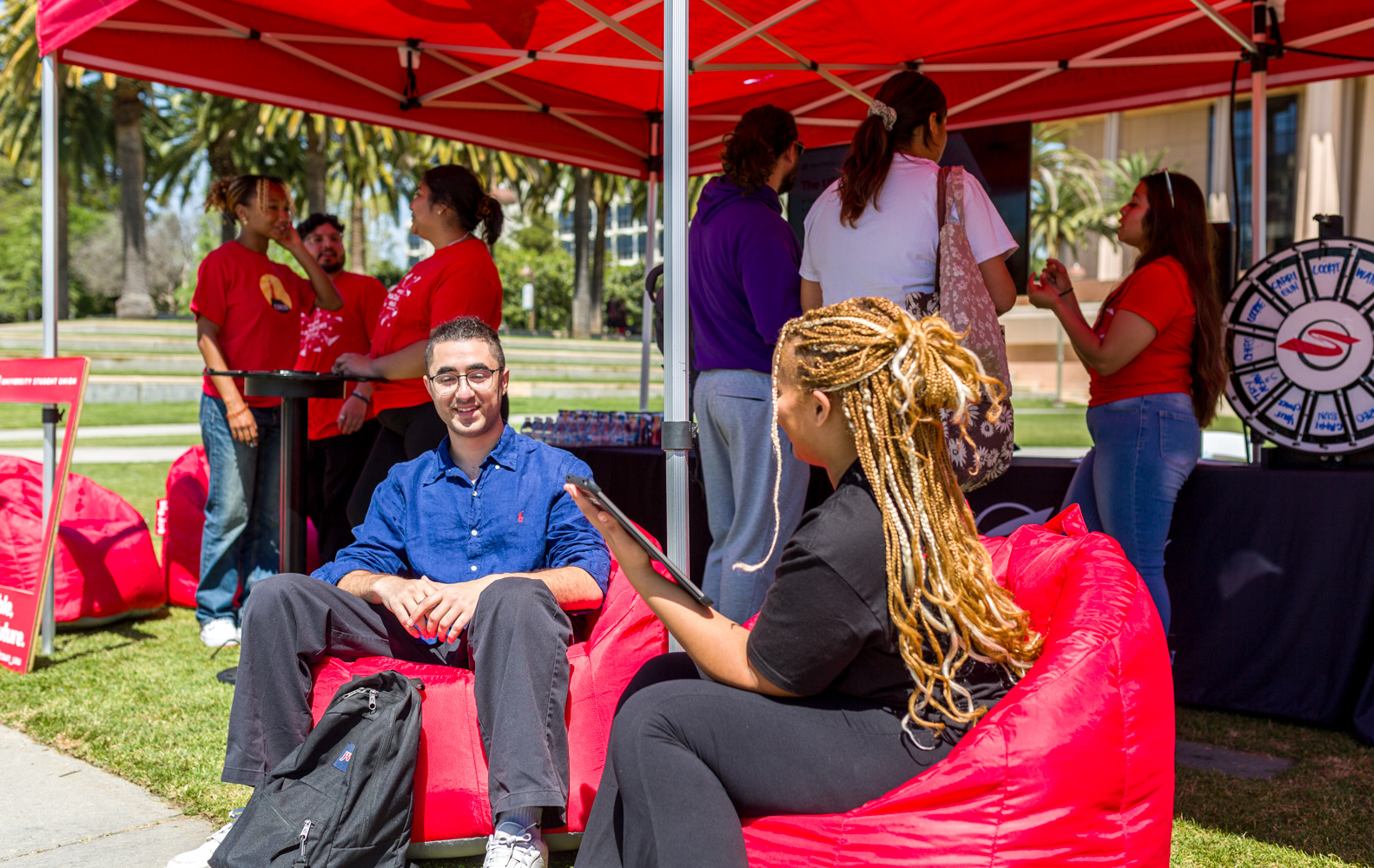 USU Heart of Campus Project Champion Jordan Brown interacts with a CSUN student.