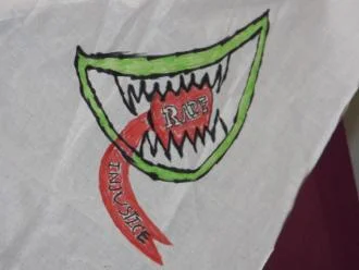 Close up of artwork on a bandana. Art is a mouth with a toungue sticking out.