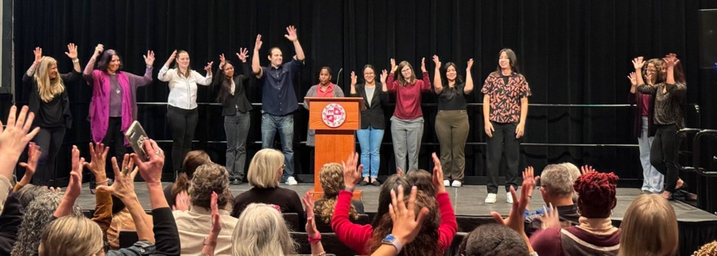 People on stage for the first cohort of 8 PRISM-Ed Scholars