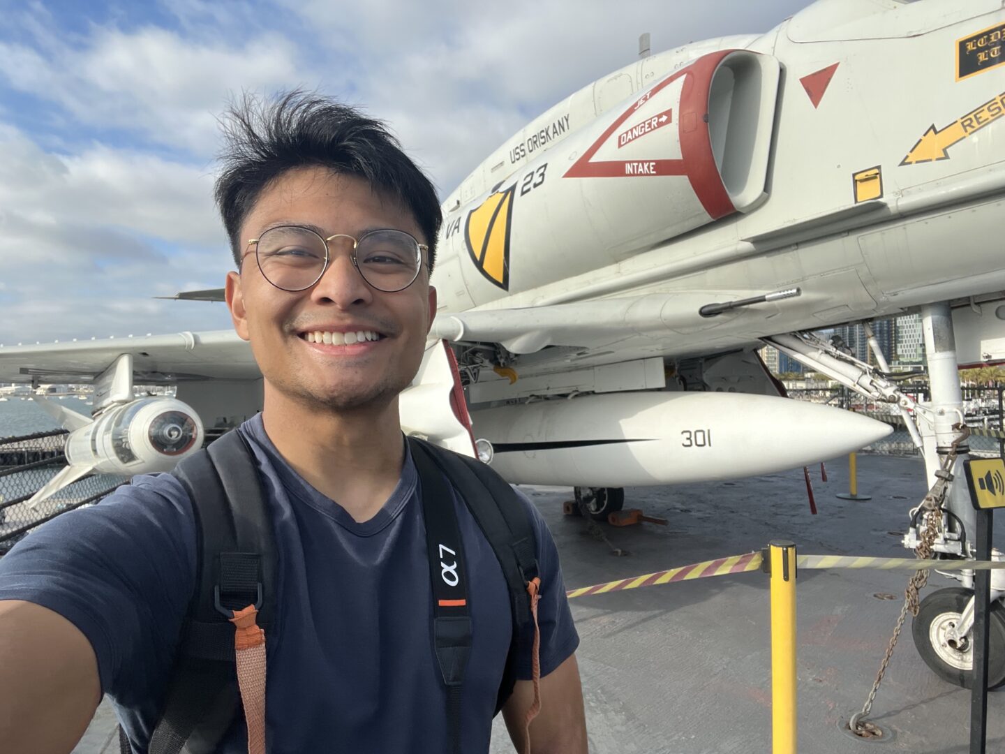 Joshua Cabal Taking a photo of himself with an aircraft in the background