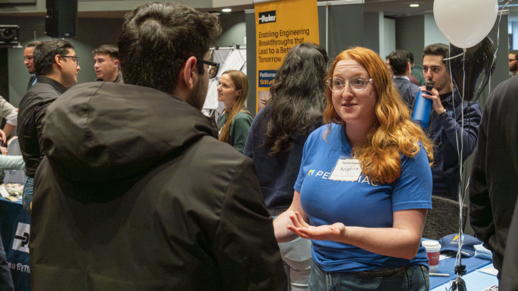 PennyMac Representative meeting with student at Tech Fest