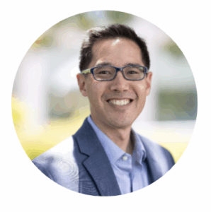 Man smiling wearing a suit. 