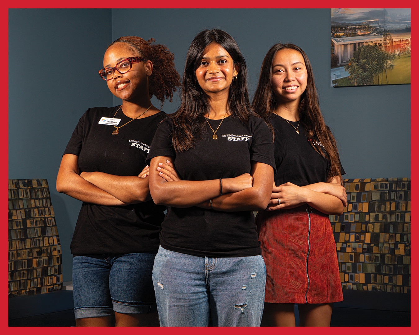 A group of three student workers standing together in the Career Center.