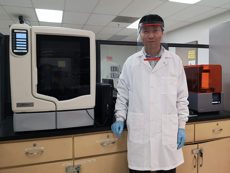 Bingbing Li, CSUN assistant professor of Manufacturing Systems Engineering, wears a face shield created in his lab. Li is using 3D printers to create more than 1,500 face shields for health care workers throughout Los Angeles. Photo courtesy of Bingbing Li.