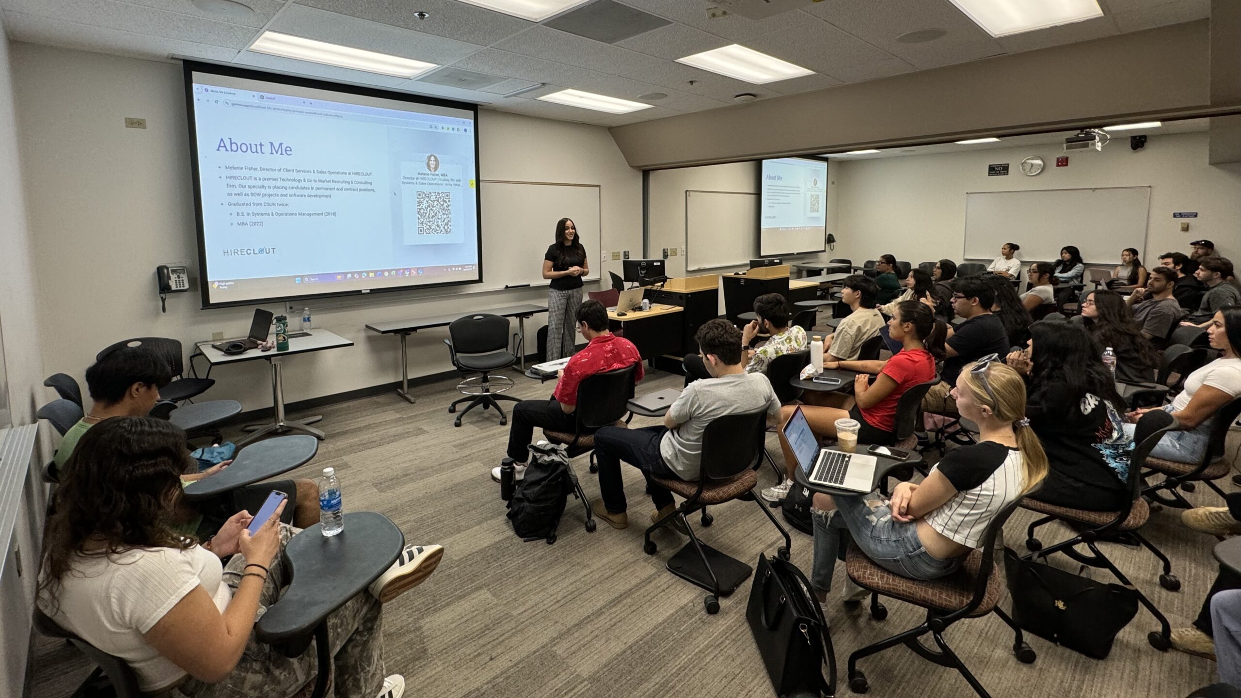 Melanie Fisher speaking to a group of students seated in a classroom