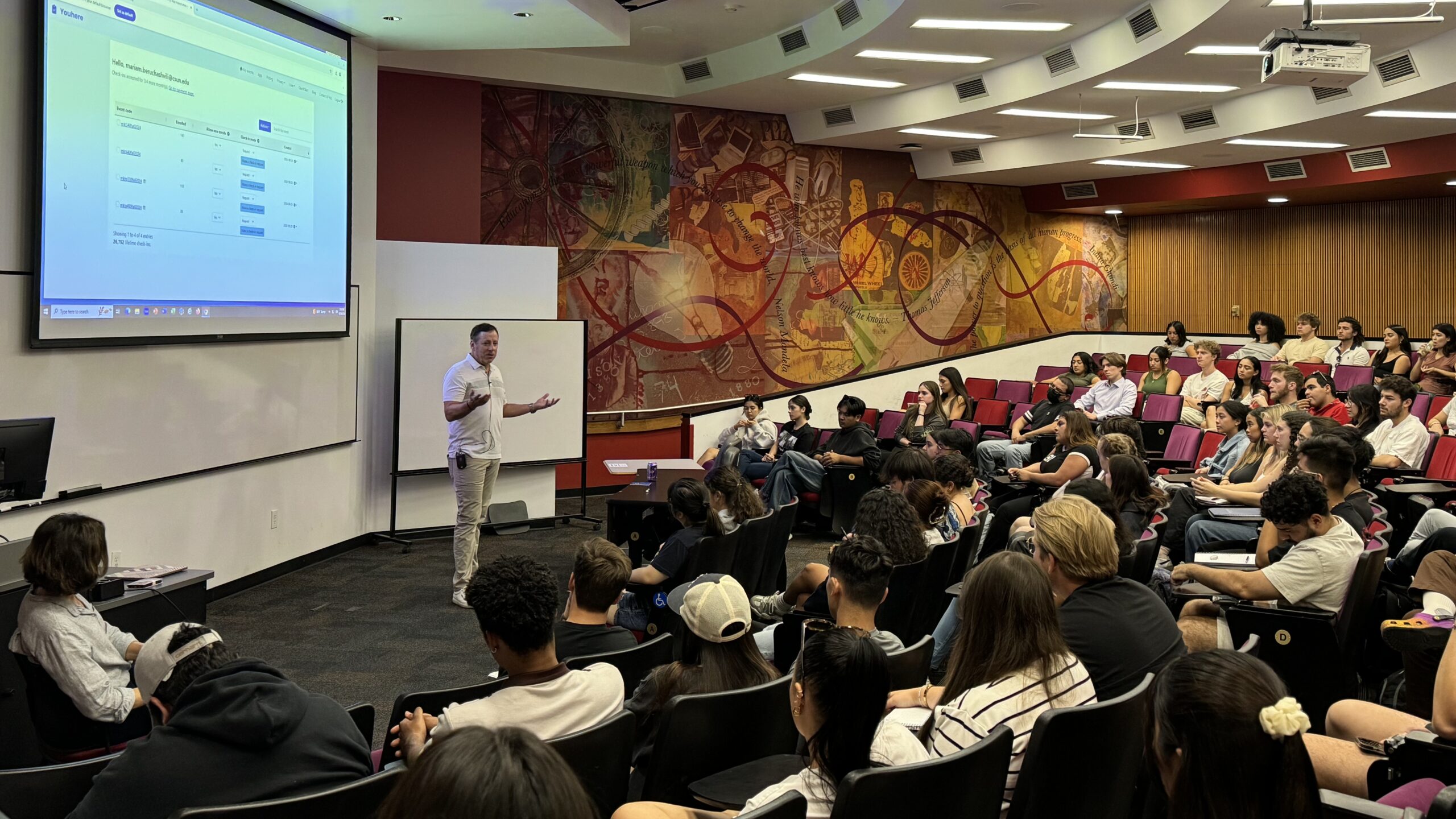 Steve Rabuchin speaking to a group of students seated in a classroom
