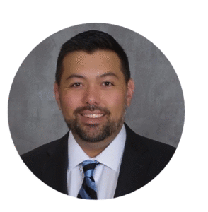 Professional headshot of a man wearing a suit. 