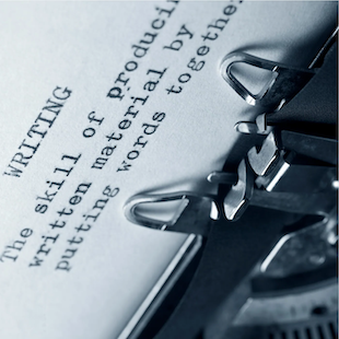 Close-up of a typewriter typing text on white paper