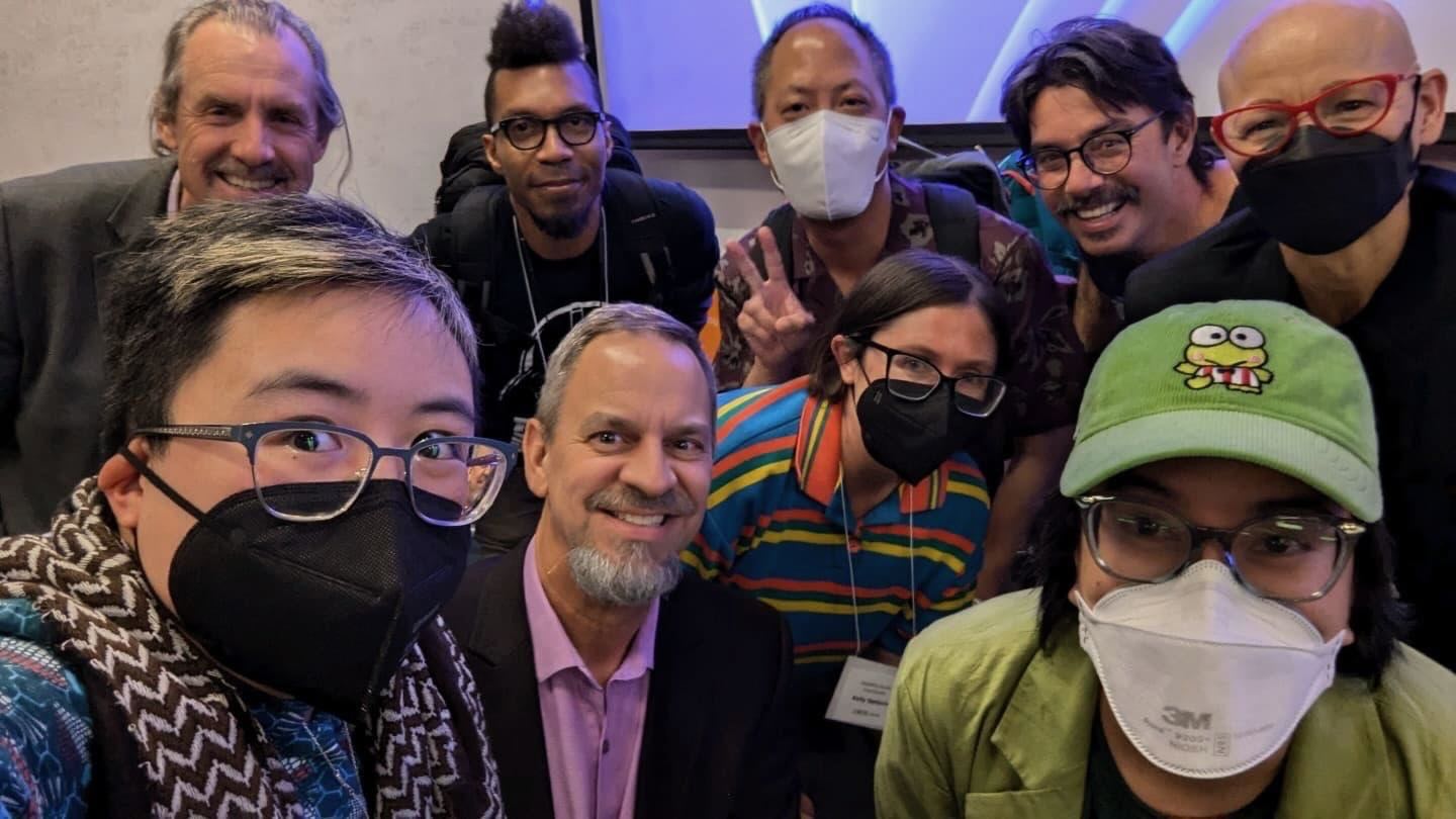 Disability Studies faculty and disability activists surround Ly XZ Brown and Dean Reeder