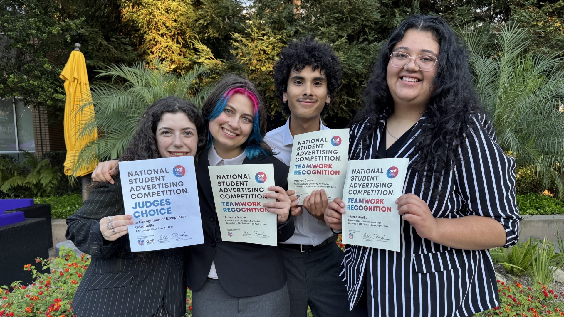 Four CSUN students smiling proudly